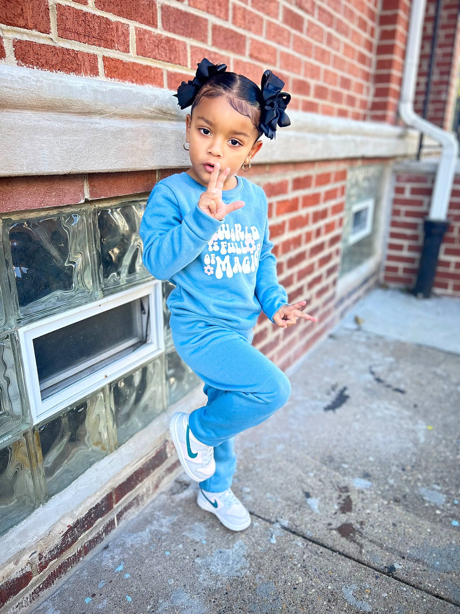 Legacy is registered to the contest to win money with this photo: brick, brickwork, child, cool, denim, electric_blue, eyewear, flash_photography, happy, hat, human_leg, leisure, person, personal_protective_equipment, road, sitting, sleeve, sportswear, t_shirt, toddler