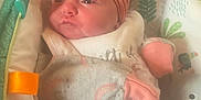 Addison is registered to the contest to win money with this photo: baby, infant, headband, pink, blanket, cushion, seat, pattern, leaf, clothing, cute, pout, face, newborn, soft, resting, indoors, child, wrapped, adorable