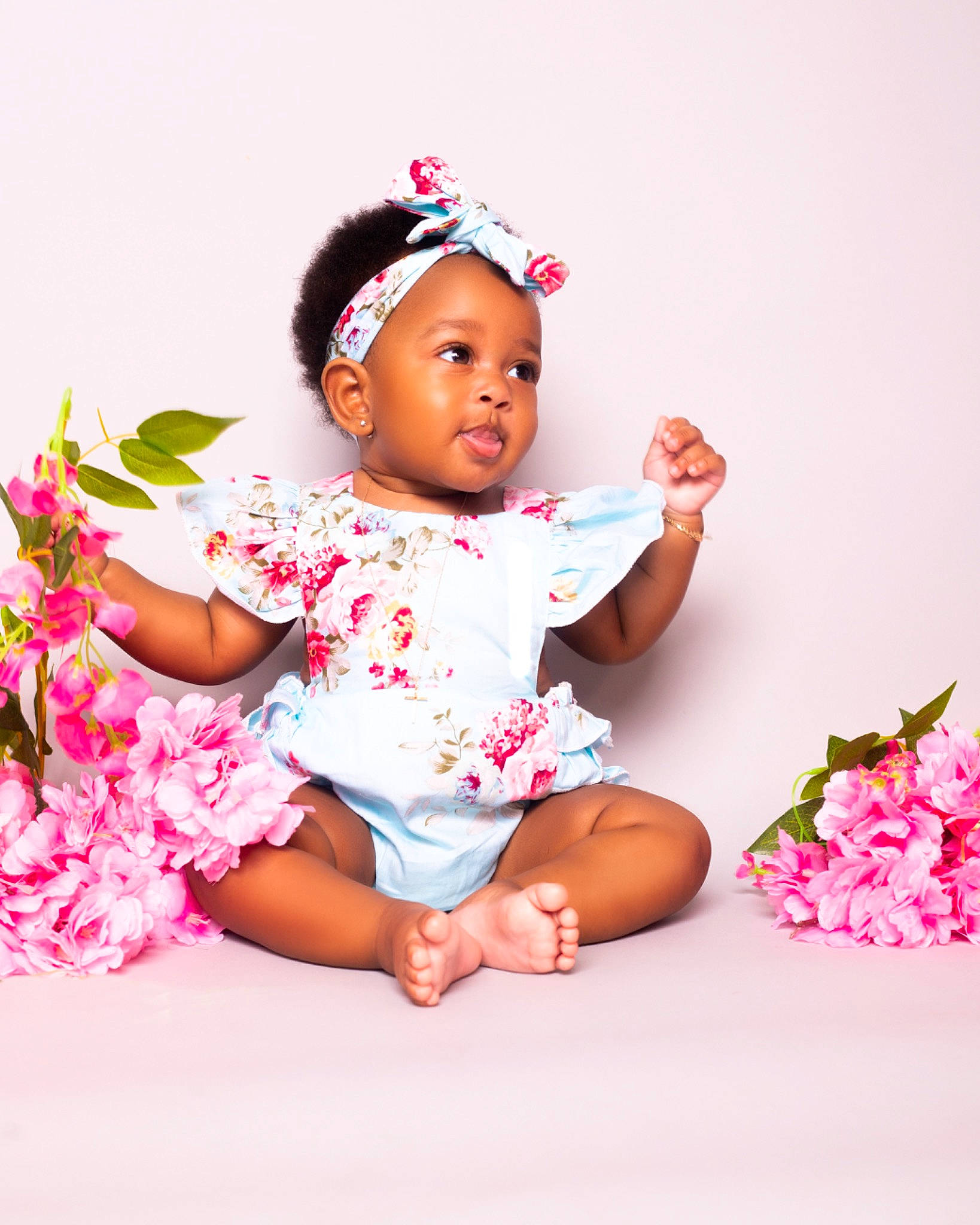 Kori is registered to the contest to win money with this photo: baby, baby_toddler_clothing, cap, cheek, child, dress, facial_expression, finger, flash_photography, flower, fun, happy, headpiece, magenta, people_in_nature, person, petal, pink, skin, sleeve