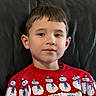 child, boy, portrait, indoors, sitting, smiling, face, head, eyes, hair, sweater, christmas, snowman, winter, controller, gaming, video_game, chair, leather, close_up