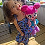 Kilanna joined the competition — help win amazing prizes! butterfly_pattern, chair, child, curly_hair, cute, daylight, dress, girl, happy, nature, outdoor, person, playful, plush_toy, sandals, smiling, summer, sunlight, toy, wooden_deck