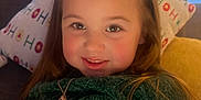 Mirabella joined the competition — help win amazing prizes! child, smile, blanket, green_clothing, long_hair, necklace, couch, pillow, holiday_theme, indoor, window, soft_lighting, happy, face, portrait, cozy, home, cute, girl, relaxed