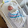 newborn, baby, hospital, bassinet, blanket, swaddled, sleeping, bottle, card, hat, infant, bed, white, striped, person, healthcare, care, cute, rest, wrapped