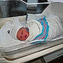 Caleb is registered to the contest to win money with this photo: baby, bassinet, bed, blanket, bottle, comfort, crib, cute, hat, healthcare, hospital, indoor, infant, medical, newborn, newborn_care, person, resting, sleeping, swaddled