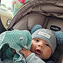 Mkilye joined the competition — help win amazing prizes! baby, infant, car_seat, hat, pom_poms, blanket, striped, clothing, child, cute, face, hand, indoor, car, seatbelt, expression, warm, snuggled, soft, person