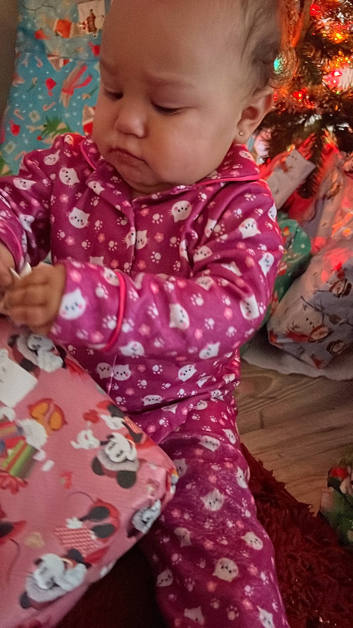 Kaylonni joined the competition — help win amazing prizes! baby, baby_toddler_clothing, cheek, child, christmas_tree, event, eye, face, facial_expression, happy, head, human_body, iris, lap, pattern, person, pink, sitting, skin, sleeve