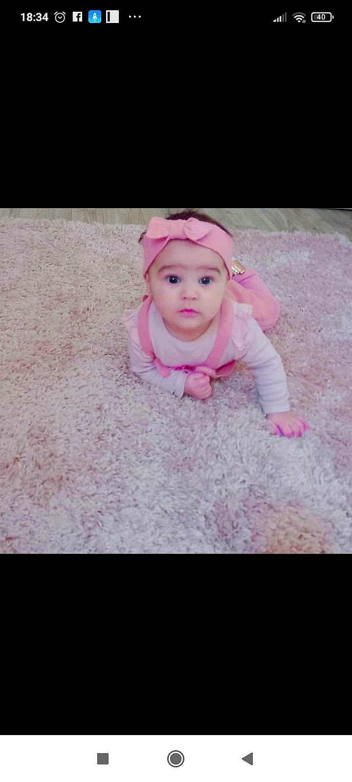 Kelya participe au concours pour gagner de l'argent avec cette photo : baby, baby_products, baby_toddler_clothing, cap, eye, eyebrow, face, flooring, fur, grass, happy, head, headwear, iris, jacket, lip, magenta, person, petal, pink