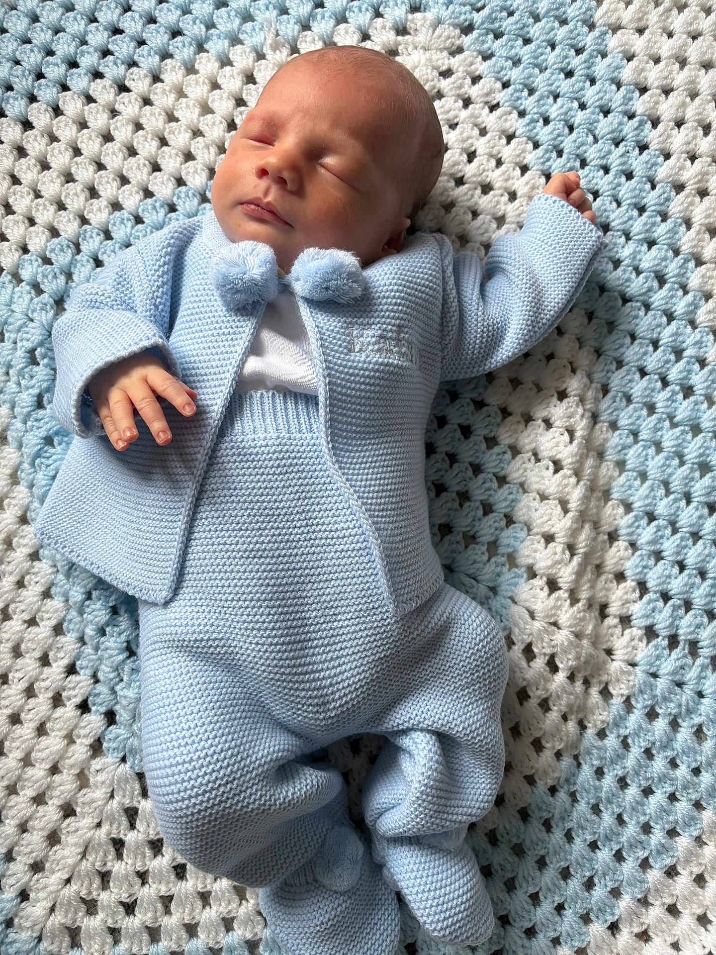 Kaison is registered to the contest to win money with this photo: newborn, baby, sleeping, knitted_clothing, blue, blanket, crocheted, soft_texture, infant, cute, peaceful, portrait, child, cozy, laying_down, handmade, warm, small_hands, footwear, head