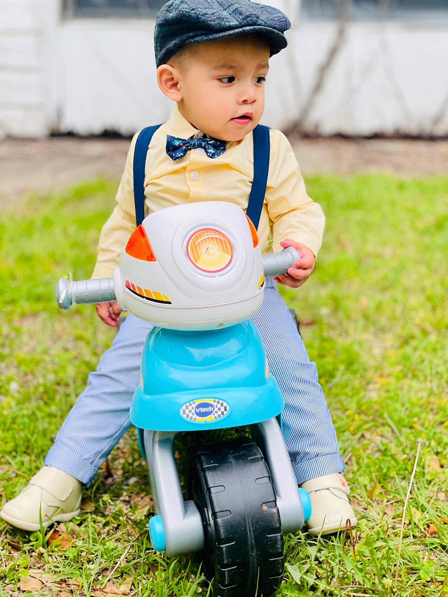 Marco is registered to the contest to win money with this photo: baby, baby_toddler_clothing, cap, child, electric_blue, grass, happy, headwear, lawn, outerwear, people_in_nature, person, photograph, recreation, riding_toy, shoe, sneakers, t_shirt, tire, toddler