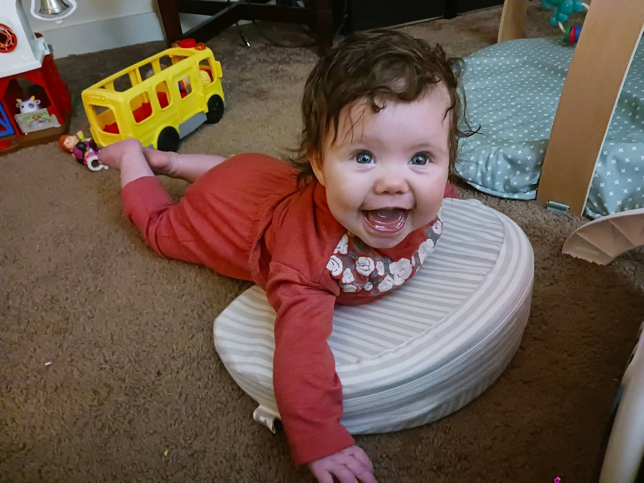 Ellie is registered to the contest to win money with this photo: aircraft, baby, baby_toddler_clothing, chair, child, floor, flooring, fun, happy, joy, laugh, person, play, room, sitting, sleeve, smile, tire, toddler, toy
