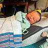 Silas Jericho Day joined the competition — help win amazing prizes! baby, newborn, blanket, smiling, infant, sleeping, cushion, clothing, face, person, indoors, furniture, television, carpet, home, resting, cozy, wrapped, soft, cute