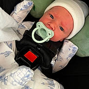 Silas Jericho Day joined the competition — help win amazing prizes! baby, blanket, blue_eyes, car_seat, child, close_up, comfort, cute, face, indoor, infant, newborn, pacifier, pajamas, plush_toy, resting, safety_harness, sleepy, soft_toy, white_beanie