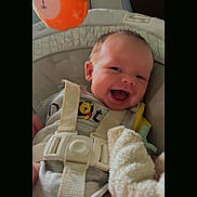 Silas Jericho Day is registered to the contest to win money with this photo: baby, smile, car_seat, onesie, winnie_the_pooh, toy, orange, straps, infant, child, happy, cute, face, head, seat, fabric, soft_toy, playful, indoors, person