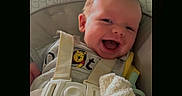 Silas Jericho Day is registered to the contest to win money with this photo: baby, car_seat, child, cute, fabric, face, happy, head, indoors, infant, onesie, orange, person, playful, seat, smile, soft_toy, straps, toy, winnie_the_pooh