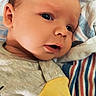 Silas Jericho Day joined the competition — help win amazing prizes! baby, blanket, closeup, clothing, cute, expression, eyes, face, hand, indoors, infant, lying_down, newborn, person, portrait, resting, skin, soft_light, striped, yellow_sleeve