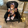 baby, child, pacifier, headband, denim_overalls, teddy_bear, chair, black_chair, indoor, wooden_floor, bar_stool, gold, rug, cute, sitting, curious, footwear, pink_shoes, person, infant
