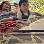 Yonathan joined the competition — help win amazing prizes! child, children, hammock, outdoor, backyard, grass, garden_tools, net, relaxing, casual_clothing, barefoot, summer, daylight, person, two_people, playful, young, sitting, curious, nature