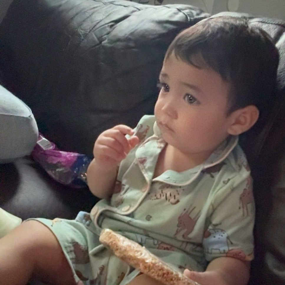 Yonathan joined the competition — help win amazing prizes! child, comfort, couch, cute, face, food, home, indoor, leather, leisure, pajamas, person, plants, relaxed, rice_cake, sitting, snack, toddler, window, young_child