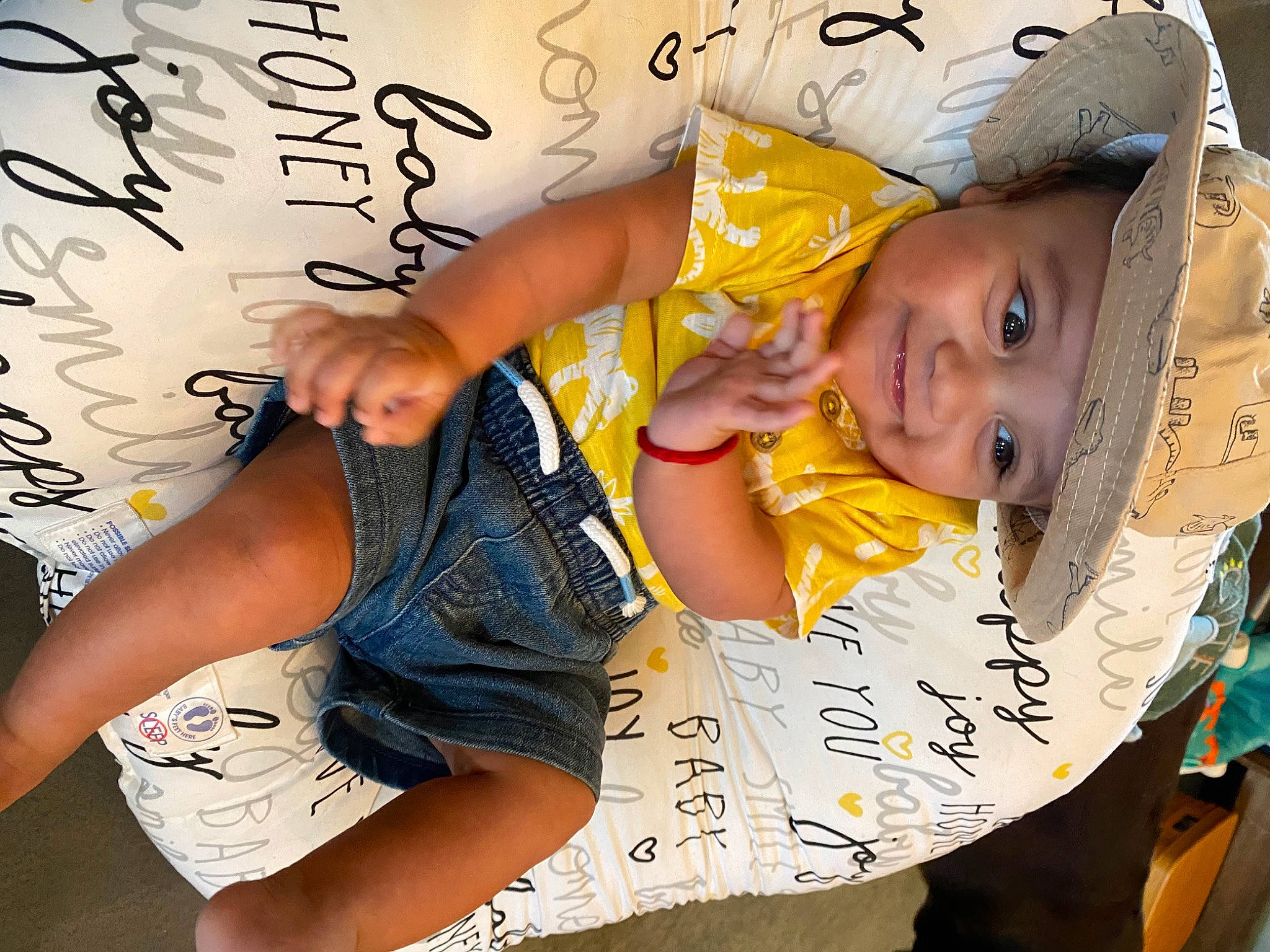 Santiago is registered to the contest to win money with this photo: baby_toddler_clothing, beauty, child, elbow, facial_expression, finger, font, foot, fun, hairstyle, happy, headwear, human, human_leg, joy, knee, leisure, person, shorts, sleeve
