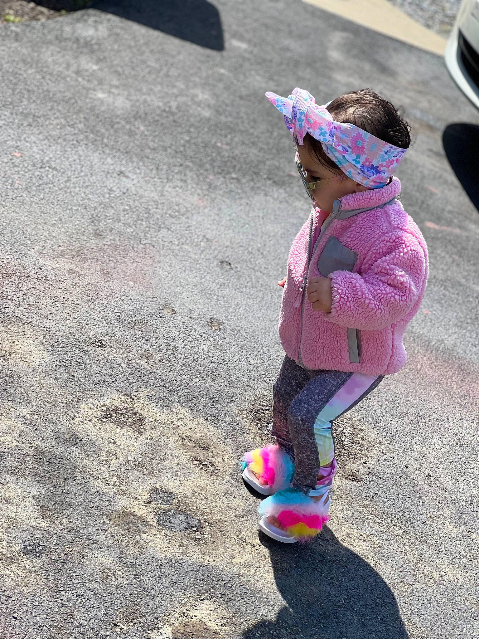 Violet is registered to the contest to win money with this photo: asphalt, baseball_cap, cap, car, child, eyewear, fun, grass, hat, leisure, magenta, person, play, recreation, road, road_surface, sidewalk, soil, sun_hat, sunglasses