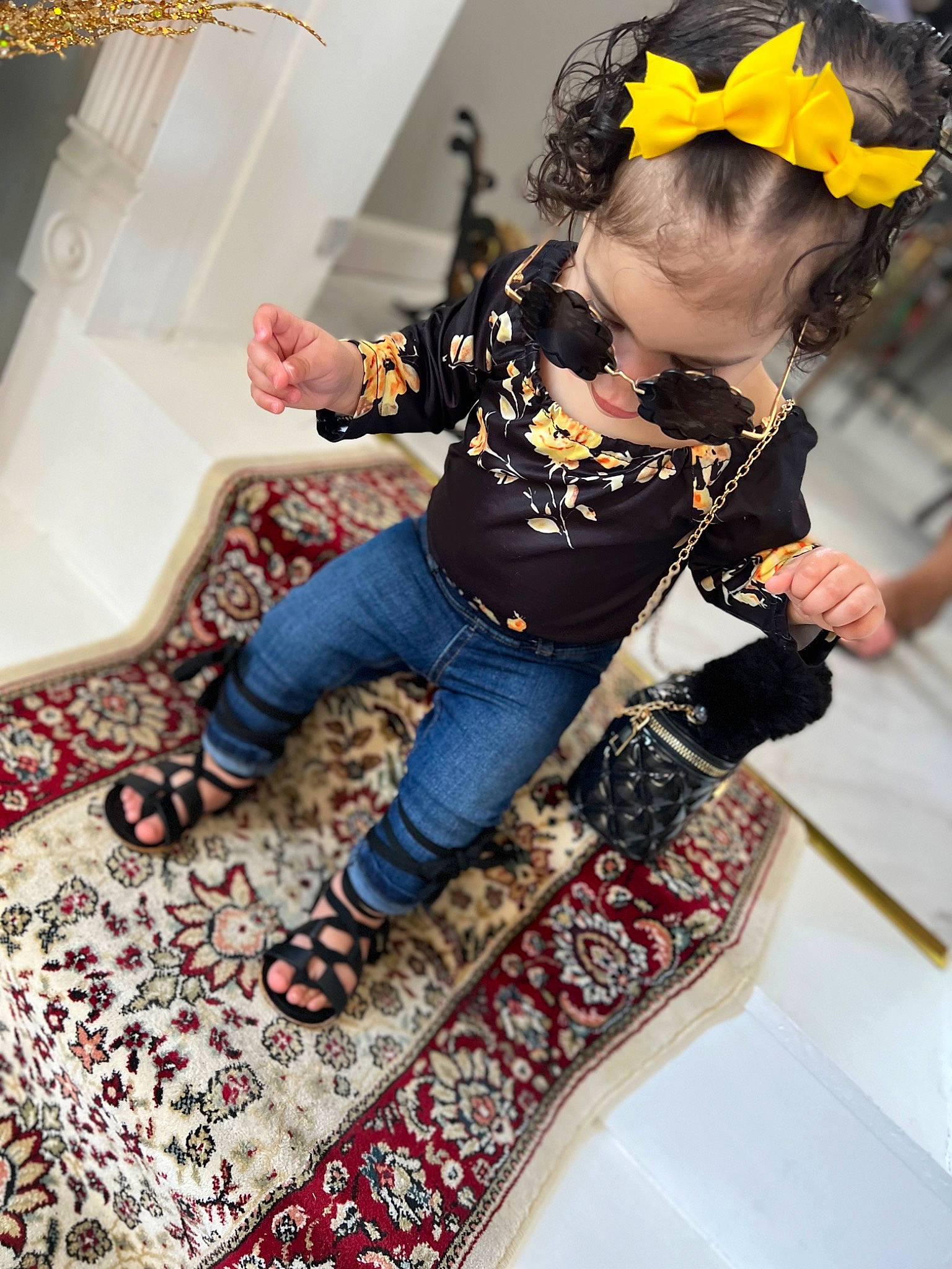 Violet is registered to the contest to win money with this photo: baby_toddler_clothing, boot, comfort, flooring, fun, happy, headband, headpiece, human_leg, jeans, knee, pattern, person, room, sitting, sleeve, sock, t_shirt, textile, thigh