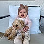 baby, child, dog, pet, cushion, chair, knitted_headband, smile, happy, cozy, indoor, clothing, socks, fur, small_dog, portrait, cute, comfort, window, hand