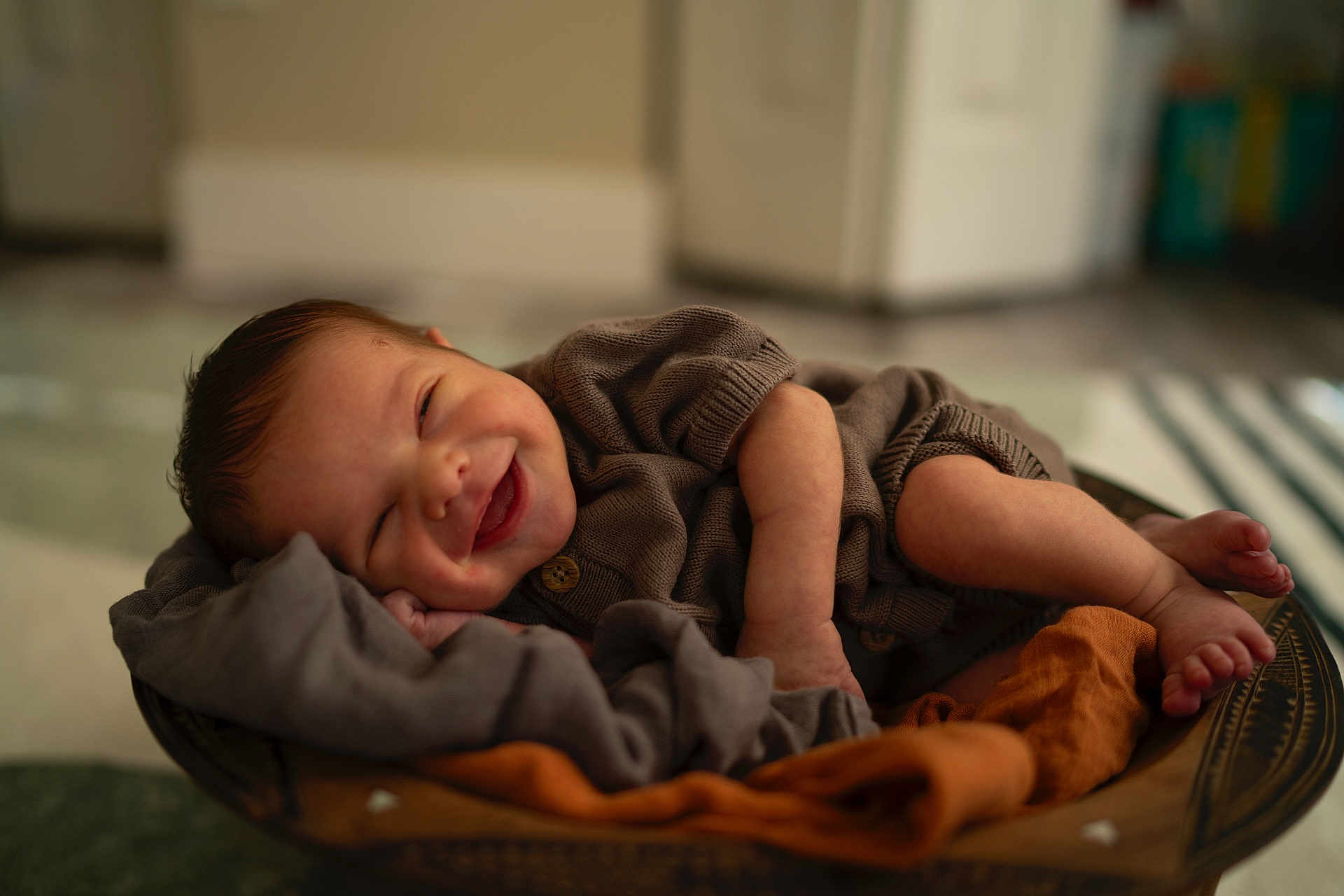 Idris is registered to the contest to win money with this photo: baby, smiling, sleeping, cozy, blanket, bowl, infant, cute, happy, clothing, face, skin, hands, feet, indoors, portrait, newborn, soft, warm, resting