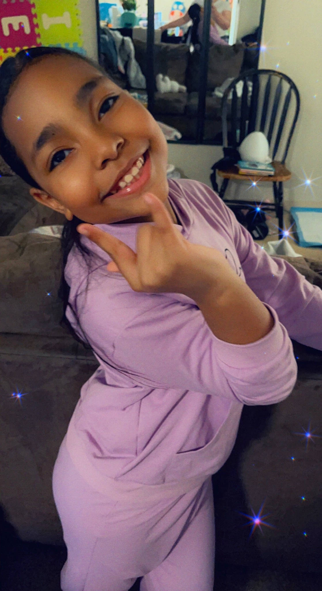 Arielle is registered to the contest to win money with this photo: abdomen, black_hair, chest, child, dress, event, flash_photography, formal_wear, fun, gesture, hair, happy, joy, mouth, person, purple, smile, suit, tableware, thigh