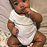 Kaiser joined the competition — help win amazing prizes! baby, infant, child, onesie, socks, curly_hair, sitting, blanket, cute, indoors, portrait, looking_up, chubby_arms, chubby_legs, skin, expression, face, person, cozy, comfortable
