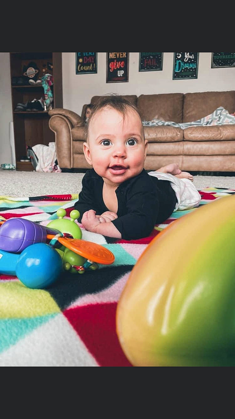 Malyiah is registered to the contest to win money with this photo: baby, baby_playing_with_toys, beauty, blurred, cheek, child, face, facial_expression, fun, happy, head, human_body, leisure, organ, people, person, product, sitting, smile, standing