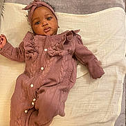 Mayana participe au concours pour gagner de l'argent avec cette photo : baby, infant, child, onesie, headband, blanket, soft_texture, lying_down, indoor, curly_hair, expressive_eyes, cozy_clothing, pink_clothing, comfortable, portrait, cute, adorable, face, skin, peaceful