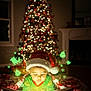 child, toddler, santa_hat, christmas_tree, book, holiday, reading, glow, green_light, blanket, indoors, festive, grinch, magic, bedtime, cozy, holiday_lights, face, pajamas, winter