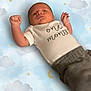 baby, infant, one_month, clothing, onesie, pants, fist, face, head, lying_down, background, clouds, stars, moon, newborn, cute, peaceful, child, portrait, soft_lighting