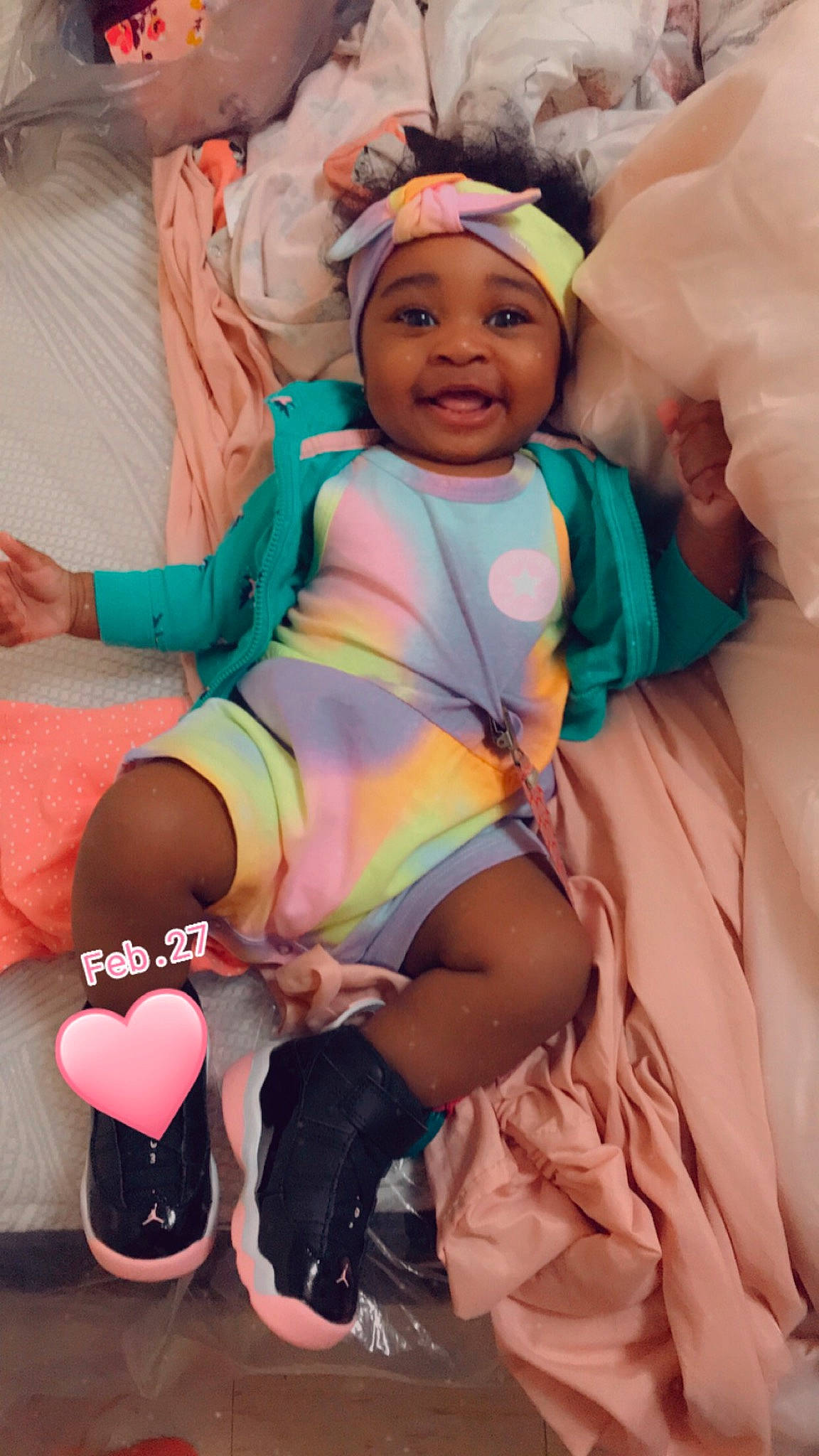 Amyia is registered to the contest to win money with this photo: abdomen, baby, baby_toddler_clothing, comfort, face, finger, fun, happy, headwear, human_body, magenta, mouth, people, person, pink, purple, skin, smile, textile, thigh