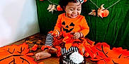 Jeshia Silgado is registered to the contest to win money with this photo: toddler, child, halloween, orange_clothing, pumpkin, decorations, striped_leggings, cake, chocolate_cake, whipped_cream, floor, leaf_cutouts, smiling, curly_hair, headband, festive, indoor, celebration, holiday, happy