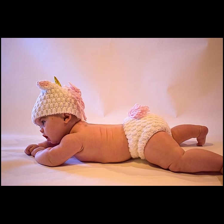 Autumn is registered to the contest to win money with this photo: abdomen, baby, comfort, elbow, flash_photography, flooring, font, foot, happy, hat, headgear, human_leg, knee, linens, magenta, pink, sandal, shoe, thigh, toddler