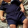 Legend is registered to the contest to win money with this photo: baby, infant, child, blue_clothing, sneakers, bedspread, patterned_bedspread, lying_down, cute, portrait, indoor, pillow, textured_clothing, shorts, shirt, small_shoes, person, young_child, resting, casual_outfit