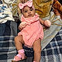 Elsy joined the competition — help win amazing prizes! baby, infant, pink_clothing, headband, bow, mittens, sandals, socks, blanket, bed, patterned_bedspread, lying_down, cute, indoors, child, portrait, soft_texture, comfortable, young_child, looking_at_camera