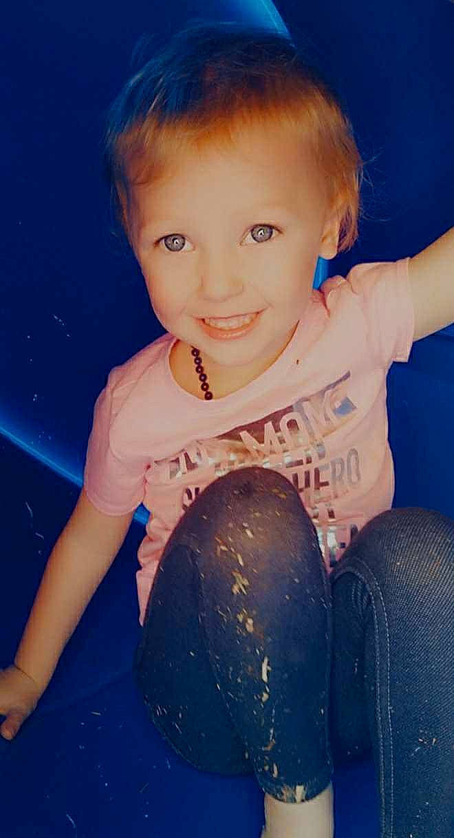 Taelyn is registered to the contest to win money with this photo: baby_toddler_clothing, blue, cheek, face, finger, flash_photography, gesture, hand, happy, human_body, iris, jeans, joint, joy, lip, neck, organ, person, shoulder, skin