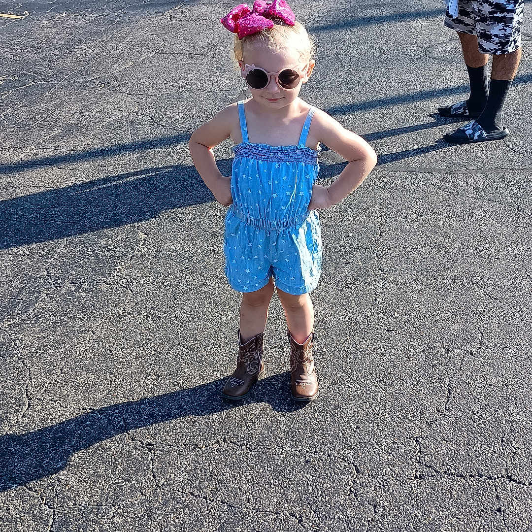 Reign is registered to the contest to win money with this photo: accessories, baseballcap, cap, child, city, clothing, face, female, girl, hat, head, person, photography, portrait, road, shorts, street, sunglasses, tarmac, urban