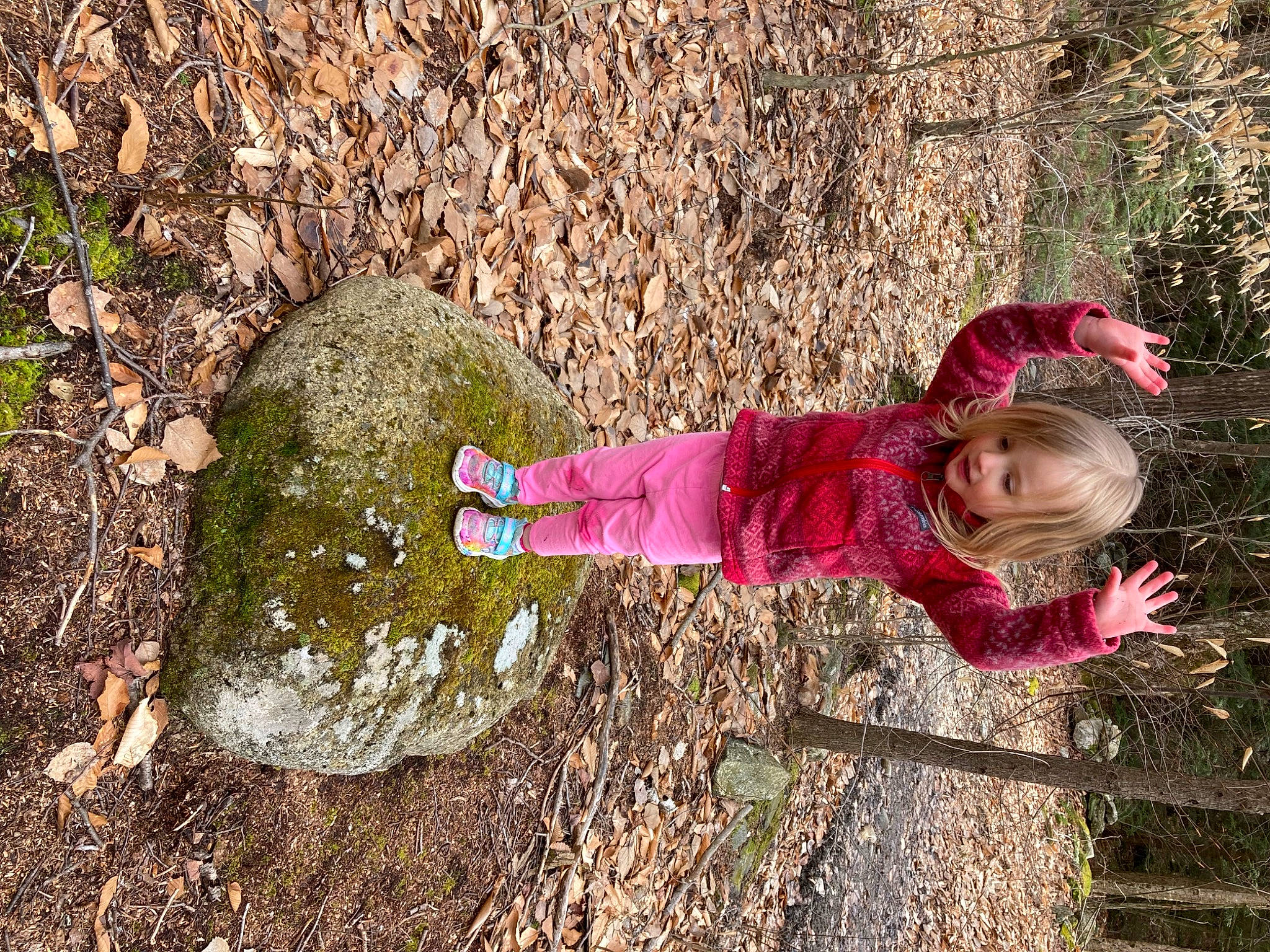 Mabel is registered to the contest to win money with this photo: adaptation, baby, baby_toddler_clothing, boot, child, fun, grass, grass_family, happy, leisure, magenta, people_in_nature, person, plant, smile, soil, toddler, tree, trunk, winter