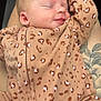 baby, newborn, sleeping, onesie, leopard_print, tattoo, leg, cozy, cute, infant, person, skin, clothing, pattern, closeup, rest, peaceful, small, cute_outfit, relaxing