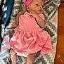 baby, infant, pink_dress, headband, blanket, patterned_blanket, newborn, cute, lying_down, indoors, wooden_surface, small_hands, small_feet, soft_fabric, heart_patch, clothing, baby_girl, resting, portrait, skin