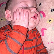 Maddox joined the competition — help win amazing prizes! baby, blanket, cheek, child, close_up, colorful_blanket, cozy, cute, face, hand, indoors, infant, onesie, orange_clothing, peaceful, portrait, resting, sleeping, soft_texture, striped_clothing