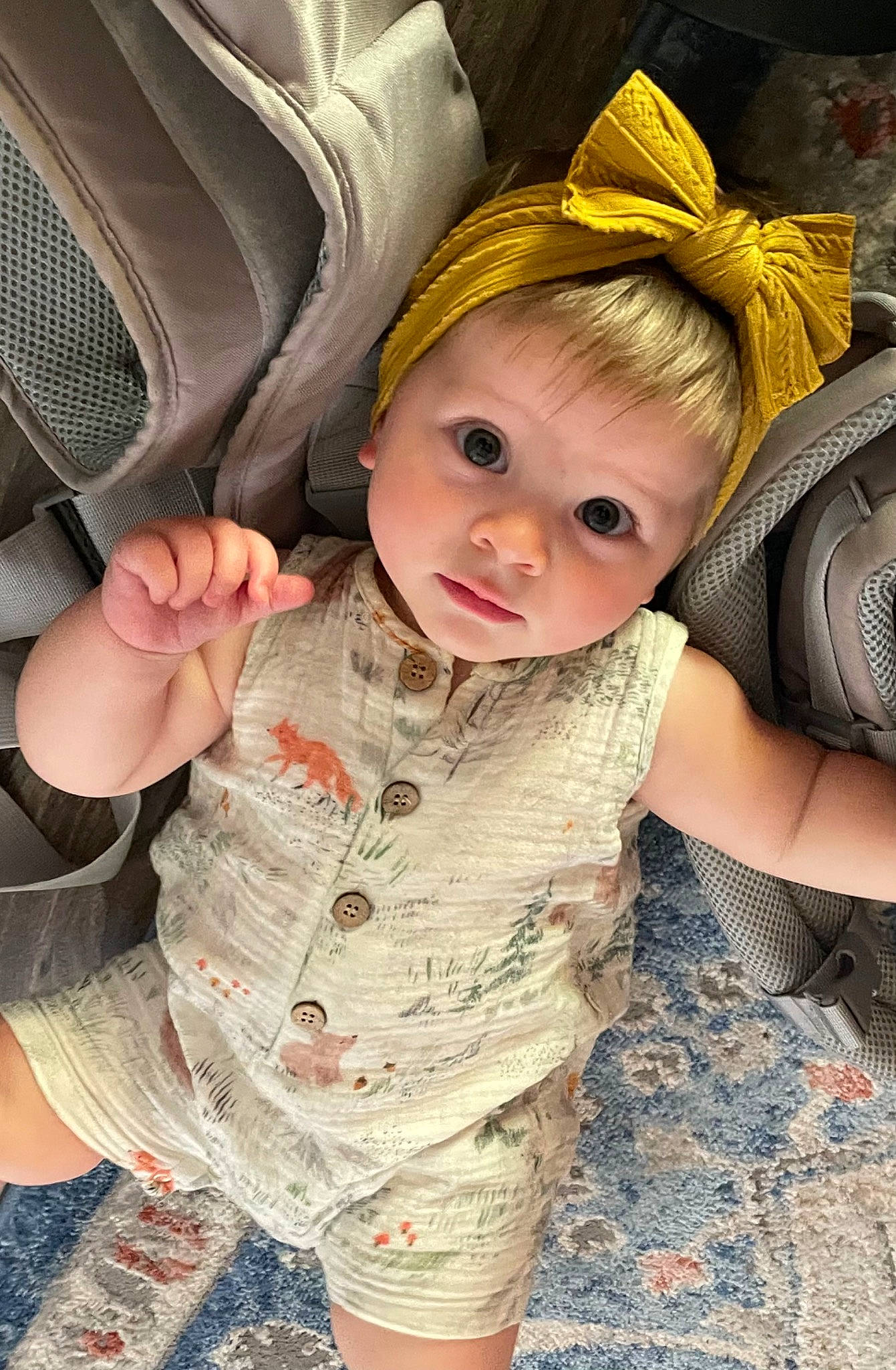 Lyla joined the competition — help win amazing prizes! baby, baby_products, baby_toddler_clothing, cheek, child, comfort, costume_hat, eye, fashion_accessory, fun, gesture, grass, happy, iris, pattern, person, sitting, skin, sleeve, thumb