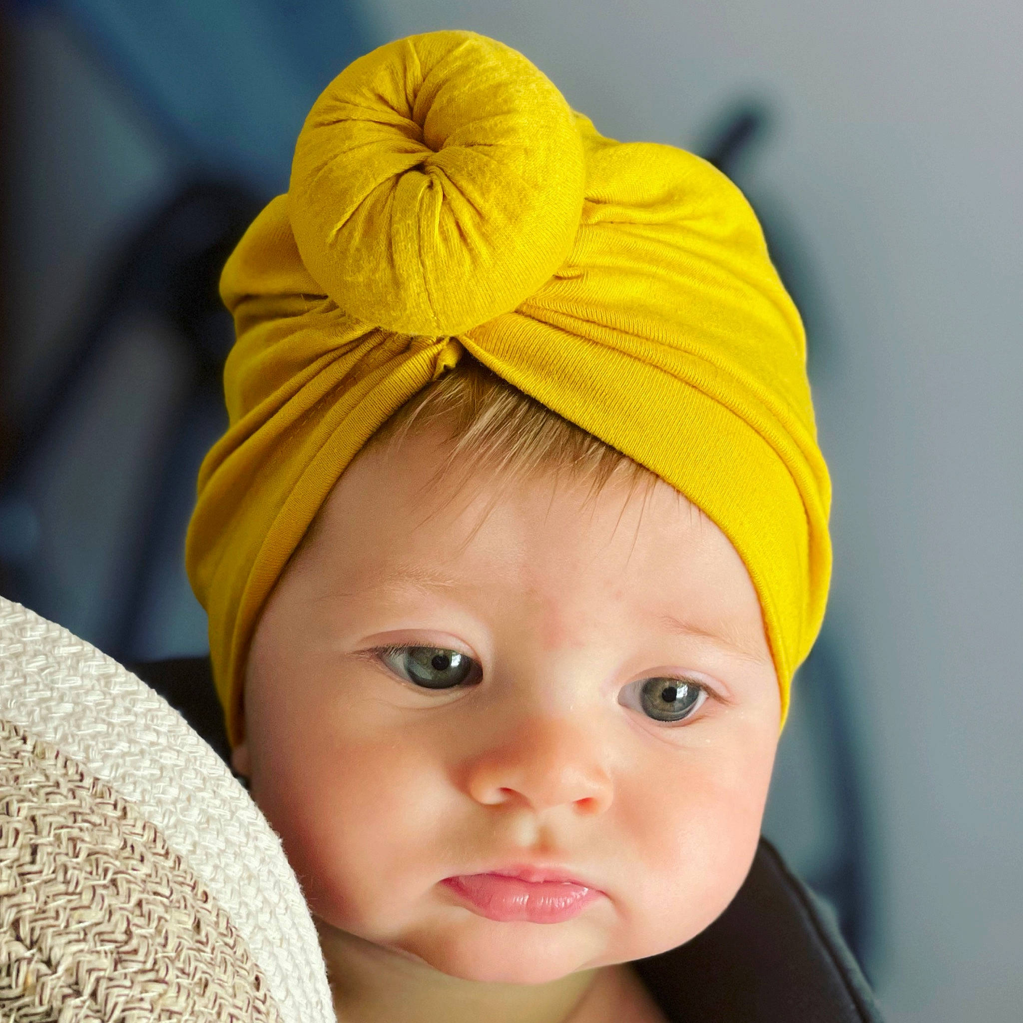 Lyla is registered to the contest to win money with this photo: baby, baby_toddler_clothing, bonnet, cap, child, costume_accessory, costume_hat, eye, eyelash, face, fashion_accessory, hair_accessory, happy, hat, head, headgear, headpiece, headwear, peach, person