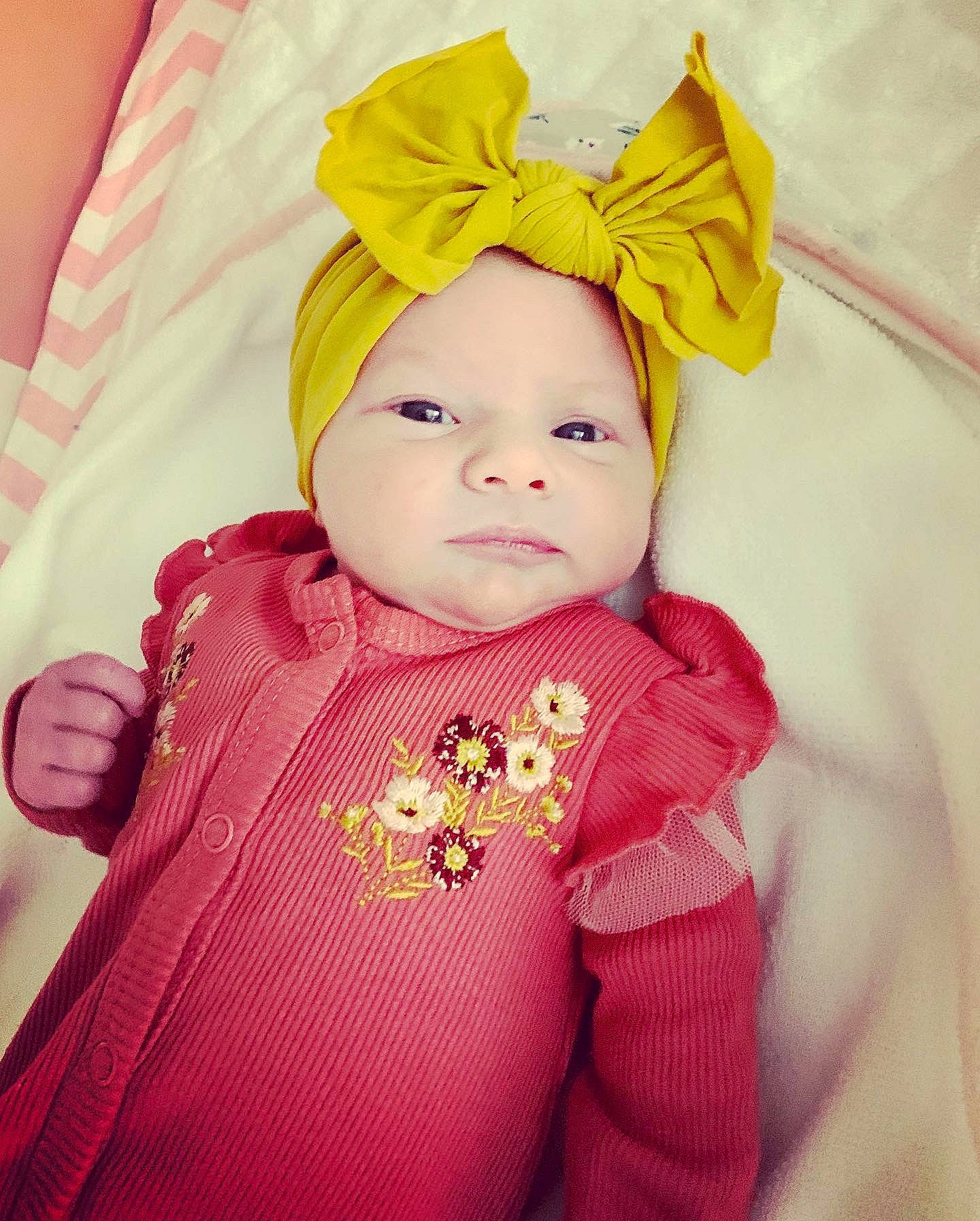 Alaska is registered to the contest to win money with this photo: baby, baby_sleeping, baby_toddler_clothing, cheek, child, comfort, costume_hat, eyebrow, fashion_accessory, happy, headband, headwear, iris, magenta, outerwear, person, pink, skin, sleeve, textile