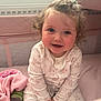 toddler, child, smiling, curly_hair, hair_clip, pink_blanket, crib, pajamas, indoors, can, baby, sitting, cute, face, happy, soft_light, cozy, infant, person, portrait