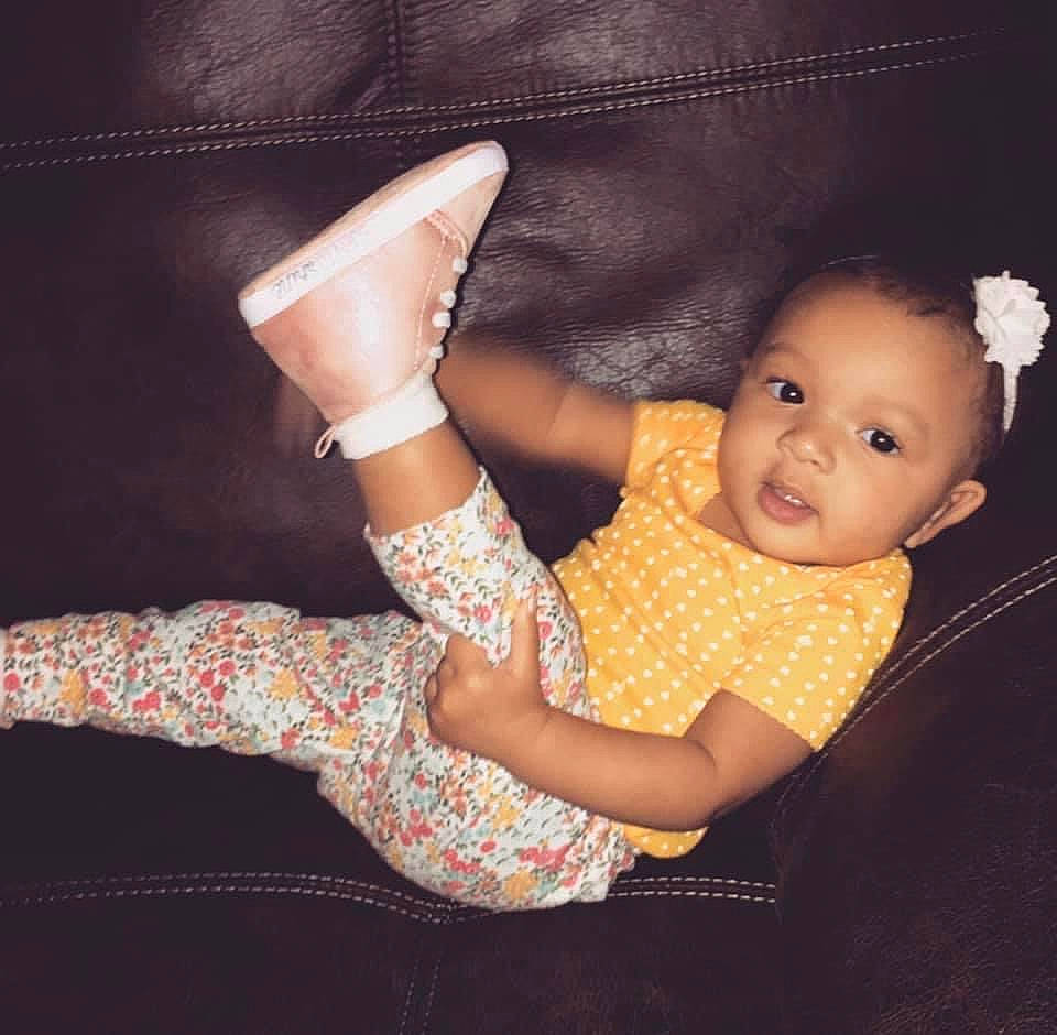 Adalia is registered to the contest to win money with this photo: arm, baby, beauty, child, child_model, design, finger, footwear, hand, human_leg, leg, pattern, person, photo_shoot, photography, pink, shoe, sitting, skin, smile