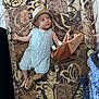 Qassim a rejoint le concours — aidez-le/la à gagner de superbes lots ! baby, hat, striped_romper, plush_toy, sandal, patterned_surface, child, infant, cute, lying_down, footwear, indoors, curious_expression, soft_toy, brown, blue, clothing, person, floor, playful